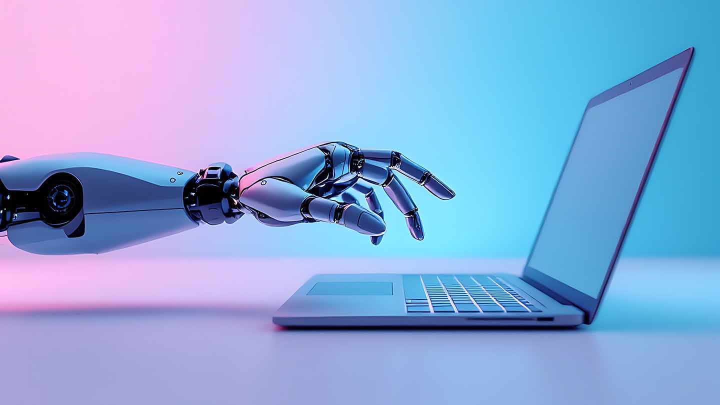 A robot hand hovers over a laptop keyboard